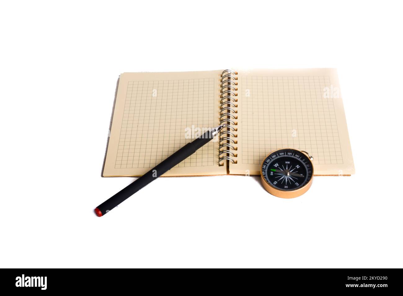 Spiral notebook and pollpoint pen and compass on a white background Stock Photo