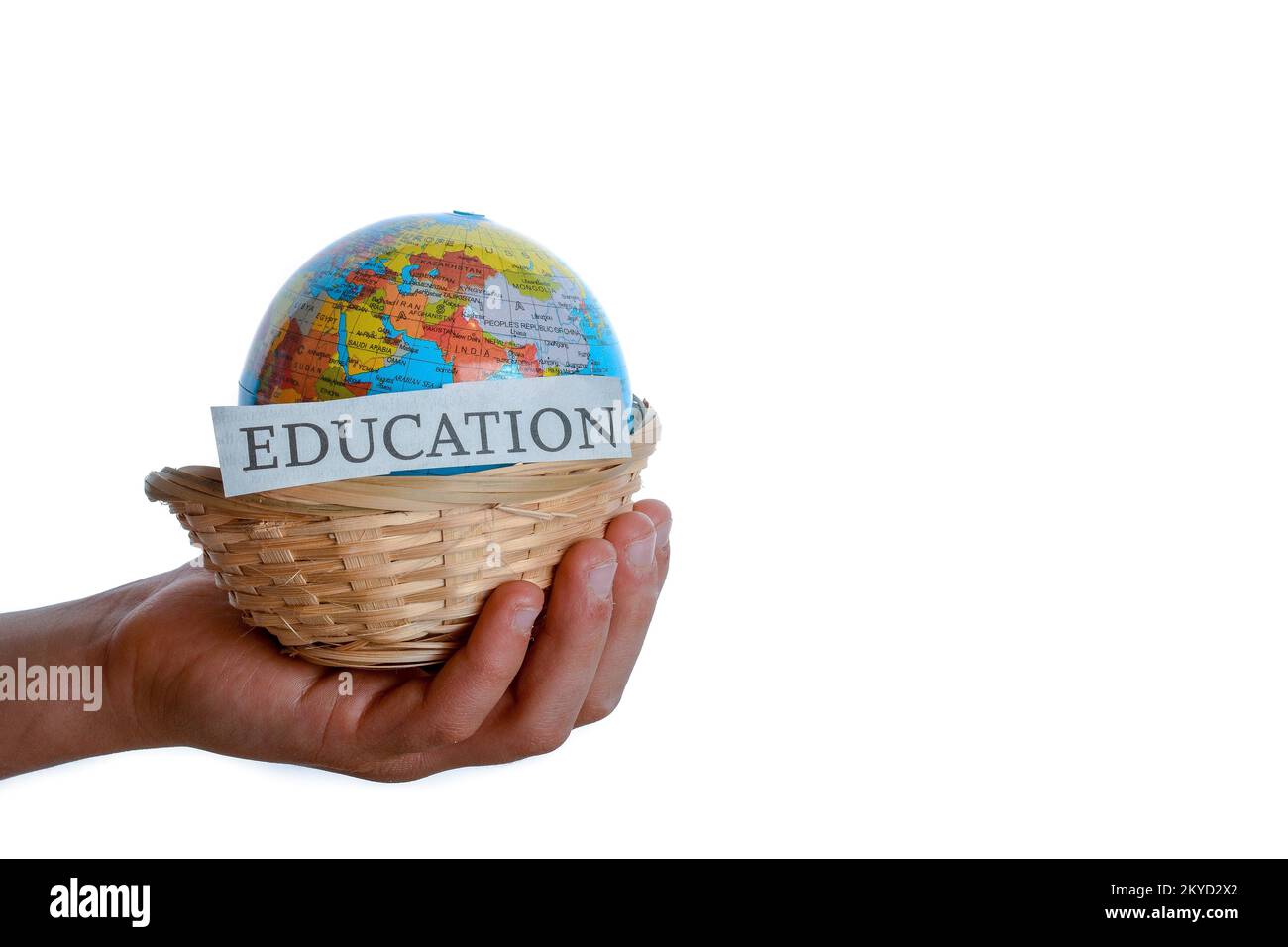 Education in one hand and globe in one hand in a basket Stock Photo