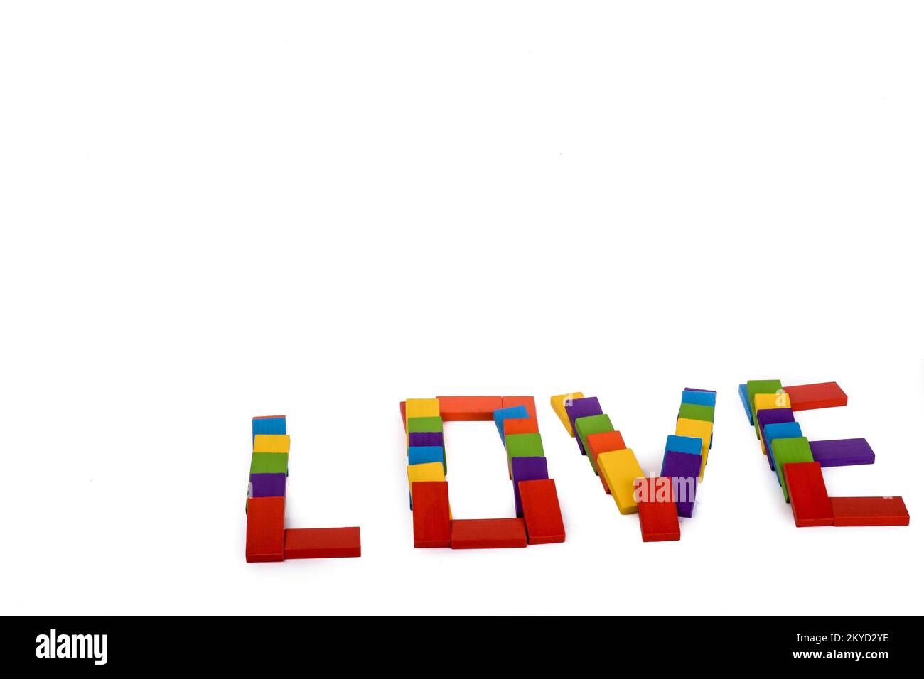 Colorful wooden dominos write the word love on a white background Stock Photo