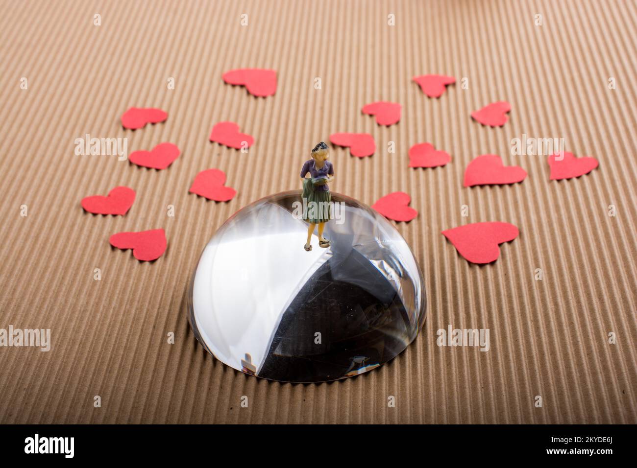 Woman figurine and Love concept with red paper hearts Stock Photo - Alamy