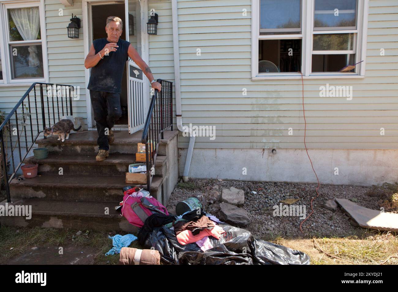 Flooding   Hurricane/Tropical Storm - Manville, N. J. , August 30, 2011  Earl Barber takes a break from helping a friend clean out her flood ravaged home in Manville, New Jersey. Residents and businesses were flooded after Hurricane Irene swept up the New Jersey coast. Andrea Booher/FEMA. New Jersey Hurricane Irene. Photographs Relating to Disasters and Emergency Management Programs, Activities, and Officials Stock Photo