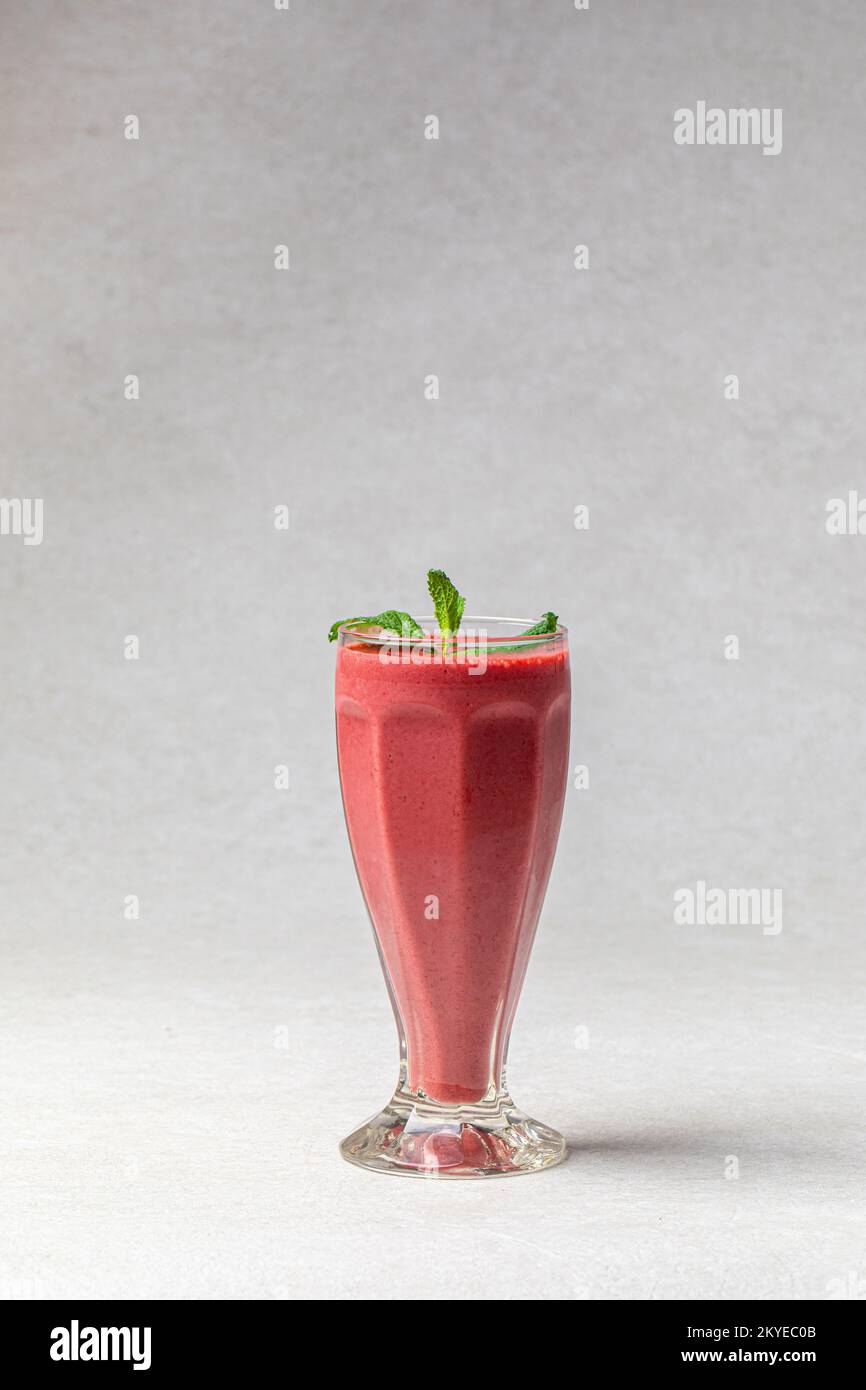 Glass of fresh berry smoothie with mint Stock Photo