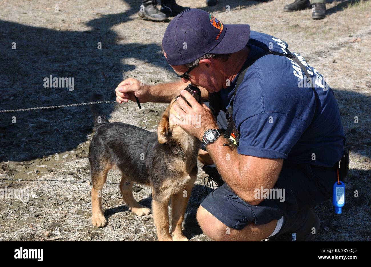 Hurricane Katrina, New Orleans, LA, September 7, 2005 -- A FEMA Urban Search and Rescue worker pets a stray dog in a neighborhood impacted by Hurricane Katrina. Jocelyn Augustino/FEMA Stock Photo
