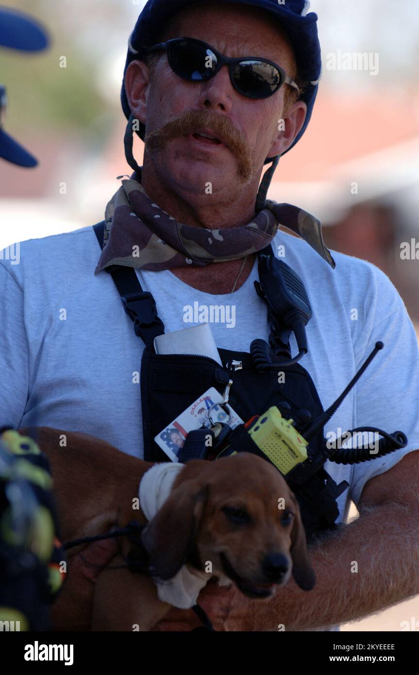 New Orleans, LA, September 7, 2005- A FEMA Urban Search and Rescue member pets a stranded dog found in areas impacted by Hurricane Katrina where the teams where doing resuce operations. Jocelyn Augustino/FEMA Stock Photo