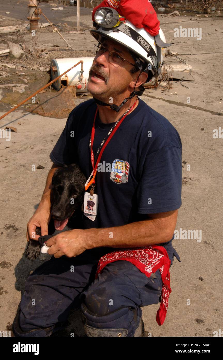Hurricane Katrina, New Orleans, LA, September 19, 2005 -- A FEMA Urban Search and Rescue worker looks after his rescue dog who injured his paw while searching in a neighborhood affected by Hurricane Katrina. Jocelyn Augustino/FEMA Stock Photo