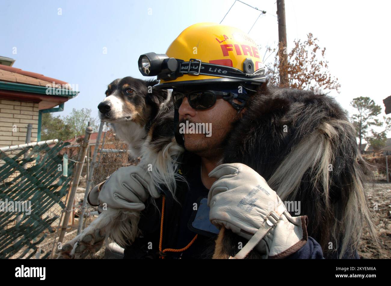 Hurricane Katrina, New Orleans, LA, September 19, 2005 -- A FEMA Urban Search and Rescue Task Force member carries his dog over an area that is muddy in an area impacted by Hurricane Katrina. Jocelyn Augustino/FEMA Stock Photo