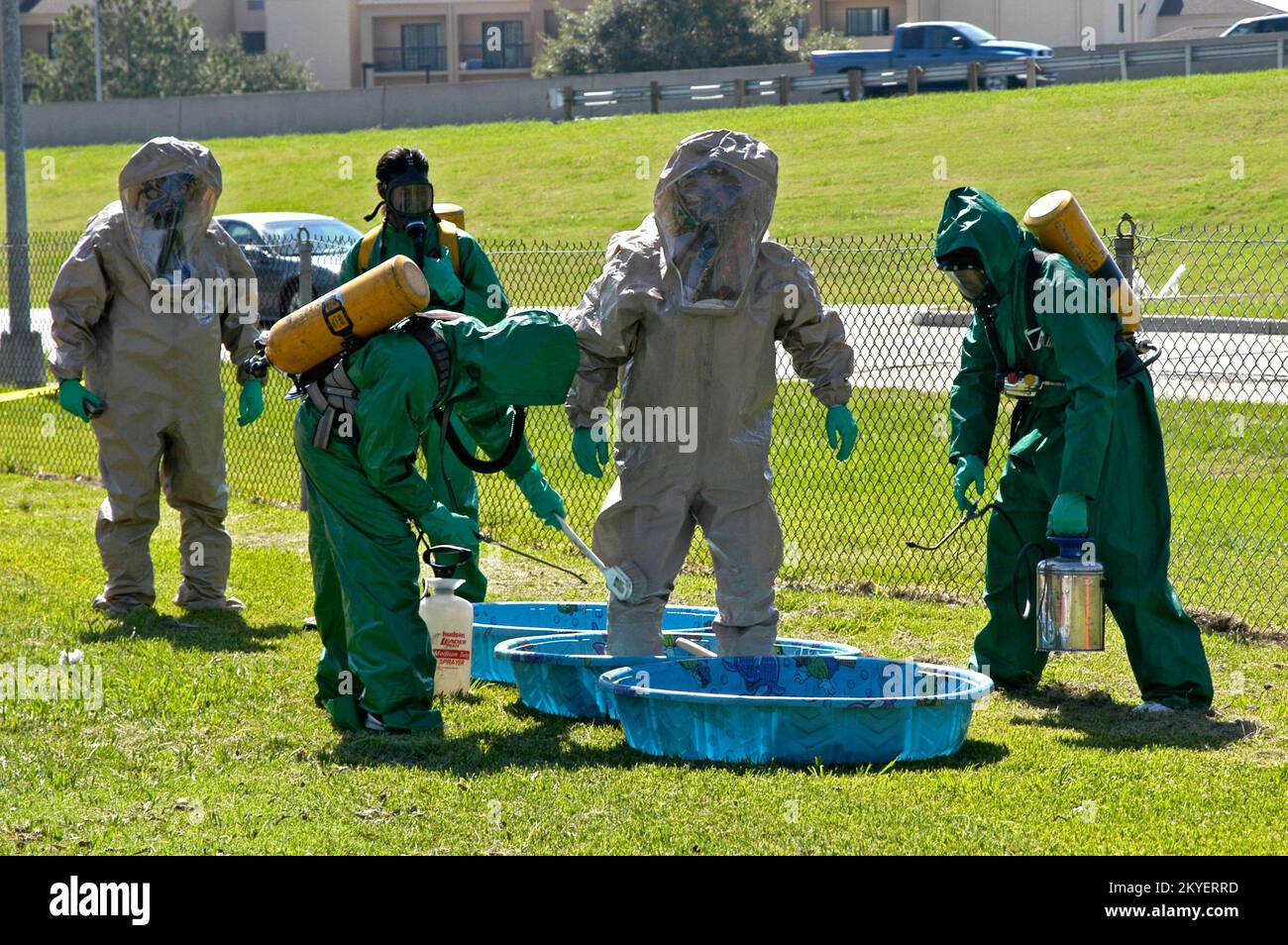 Hurricane Katrina/Hurricane Rita, Baton Rouge, La., October 9., 2005 - Members of an area Emergency Medical Technician team undergo training required for certification as rescue (grey suits) and decontamination (green suits) unit responders to hazardous material and toxic contamination situations. The HAZMAT responders who are cleaning up the spills and contaminations caused by Hurricanes Kartrina and Rita have all been certified through similar training courses. Win Henderson / FEMA Stock Photo