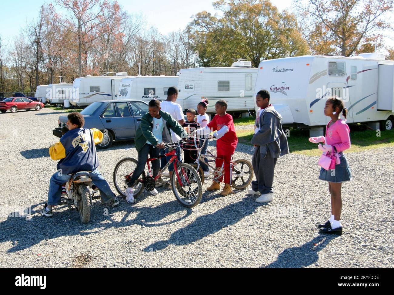 Hurricane Katrina, Baker, LA December 25, 2005 - Evacuee children waste no time enjoying their Christmas presents at the FEMA trailer park where they have been living since Hurricane Katrina forced them from their New Orleans homes. Over 600 families moved to Baker after the disaster and are living in a FEMA park. Stock Photo