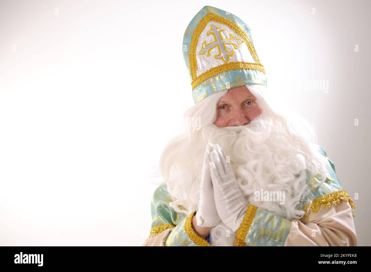 Saint Nicholas folded his hands in front of his chest as if praying and blesses everyone Sinterklaas portrait USA on a white background Dutch Santa Claus St Nicholas christmas new year Stock Photo