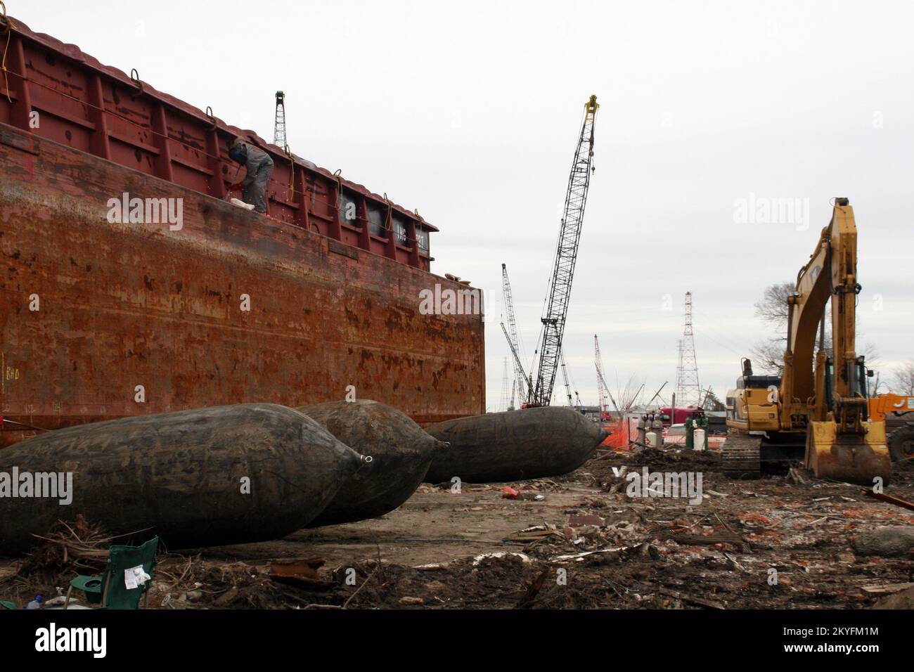 Hurricane Katrina, New Orleans, LA, February 24, 2006 - This barge, grounded at a broken levee, is lifted to help workers in dismanting it. FEMA continue levee repairs in New Orleans. Robert Kaufmann/FEMA Stock Photo