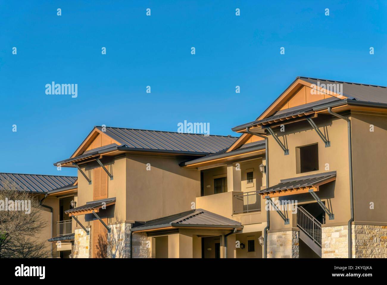 View of Austin, Texas- Brown schemed apartment building with window canopies ...