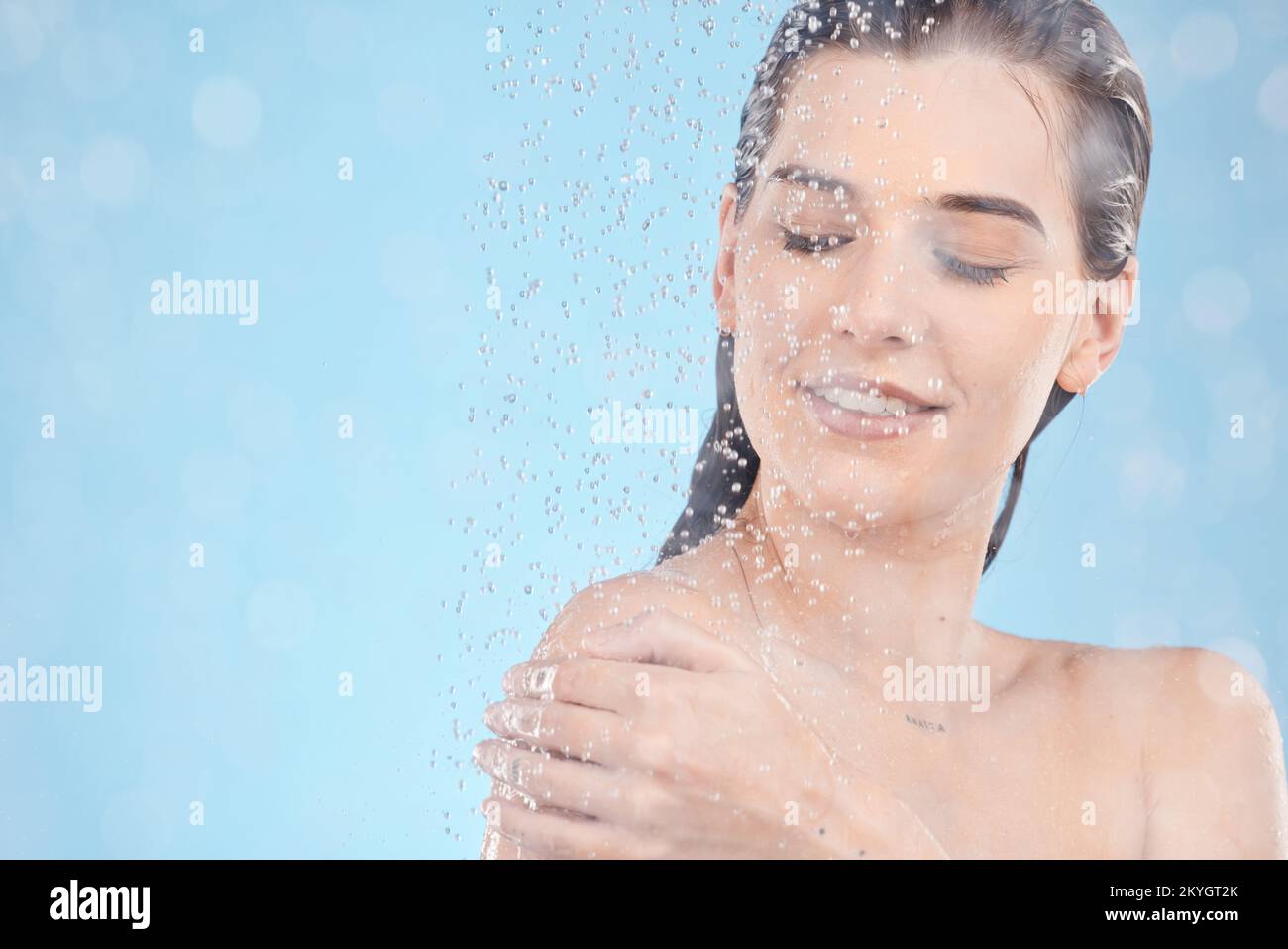 Shower, cleaning and woman with water in studio for spa wellness, body care and self care on