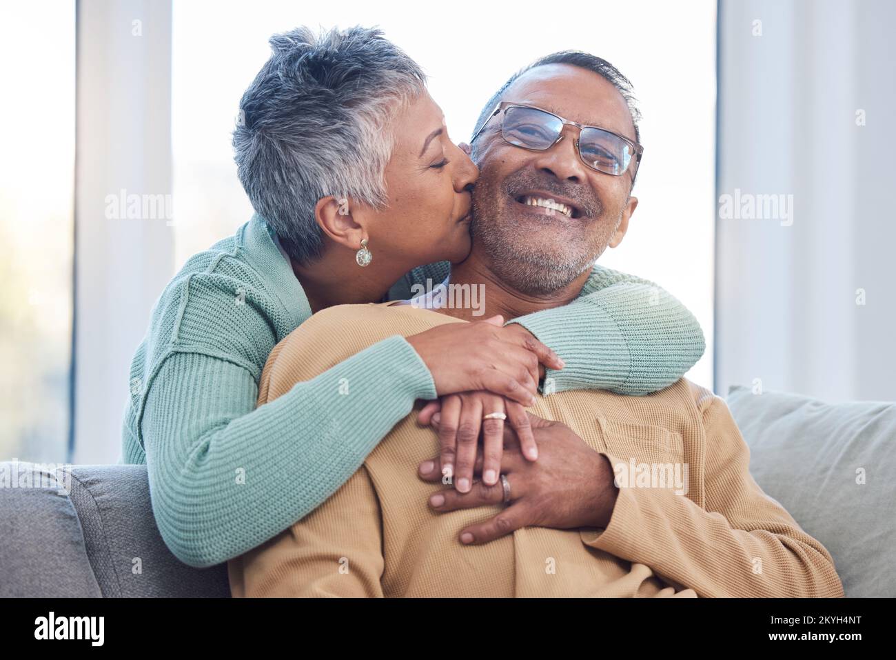 Marriage with couple, hug and kiss with love and commitment, quality time together at home and trust in relationship. Happy partner, care and strong Stock Photo