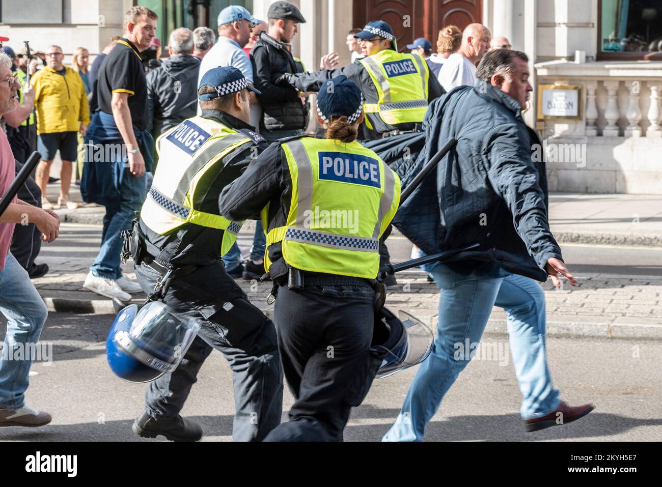 Democratic Football Lads Alliance, DFLA, march in London, UK, in a protest demonstration. Breaking through police cordon. Officers trying to stop men Stock Photo