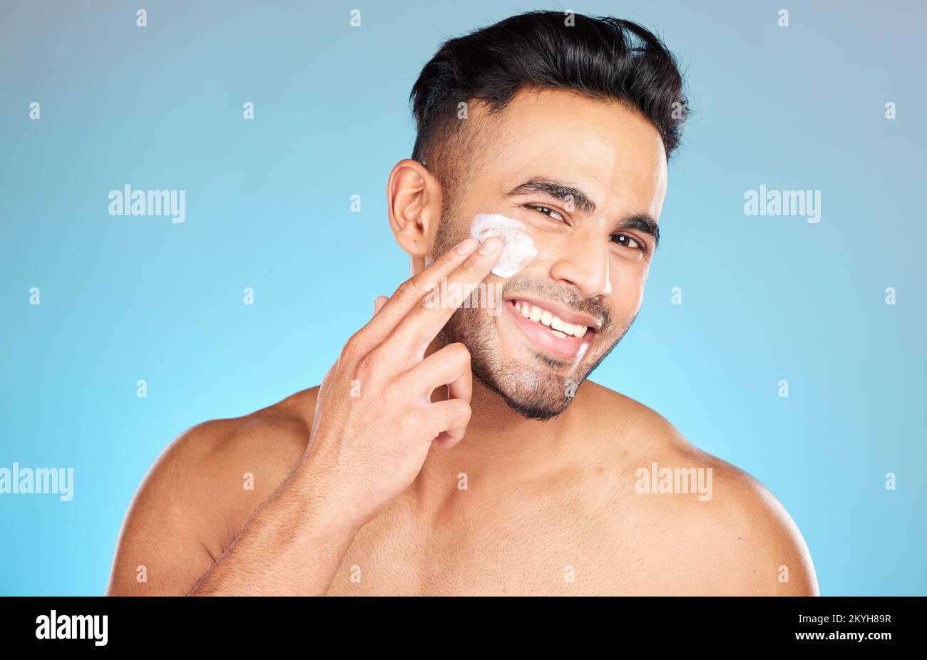 Cream, face and skincare man in studio for beauty, cosmetics and product promotion mockup with smile happy for benefits. Skin care, dermatology and Stock Photo