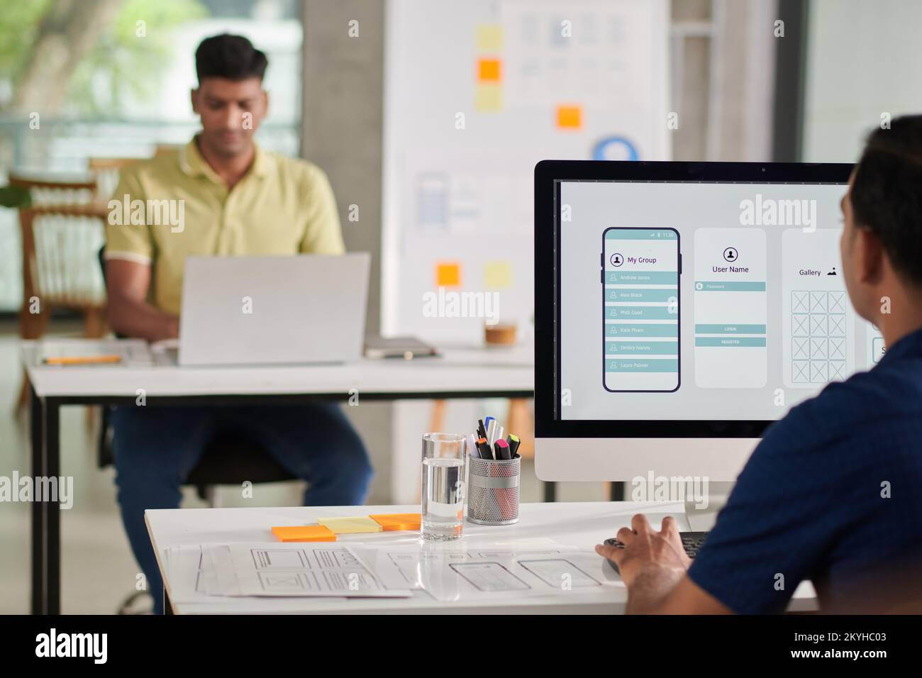 UI designer working on computer, creating interface for mobile application Stock Photo