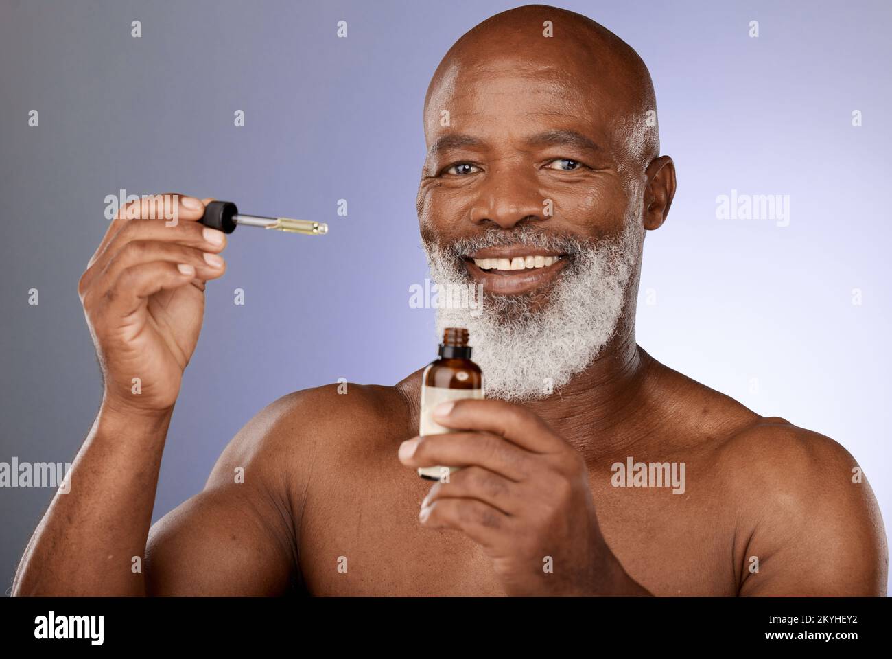 Portrait, skincare and black man with oil serum cosmetics for acne, wrinkles or anti aging protection in studio. Face, senior or old man marketing an Stock Photo