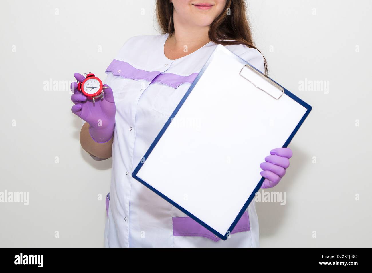 A woman points with a finger at a tablet for paper in her hands Stock Photo
