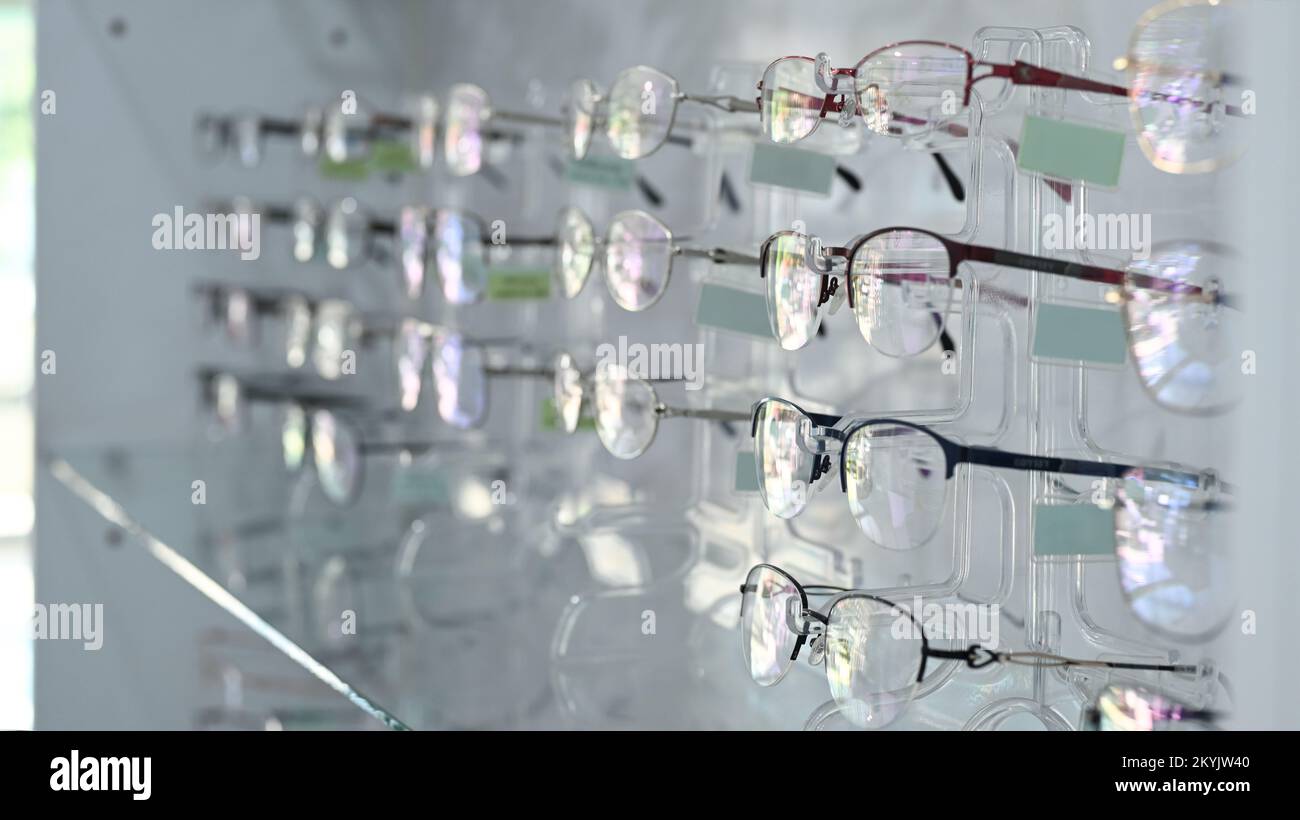 Fashionable corrective eye glasses on a shelf in optical store. Optics