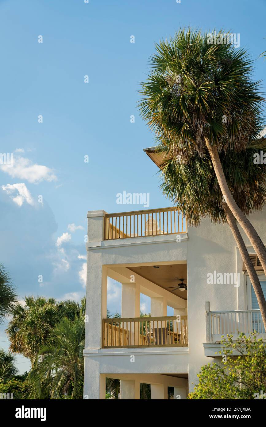 Side view of a house with multiple balconies and a sky background at