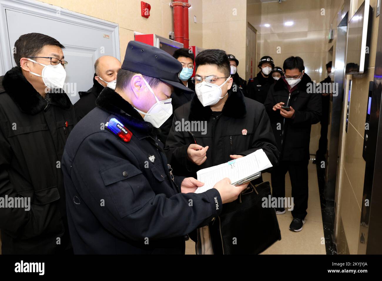 ZAOZHUANG, CHINA - DECEMBER 1, 2022 - Police officers double check the identity and property information of the person subjected to execution at a Peo Stock Photo