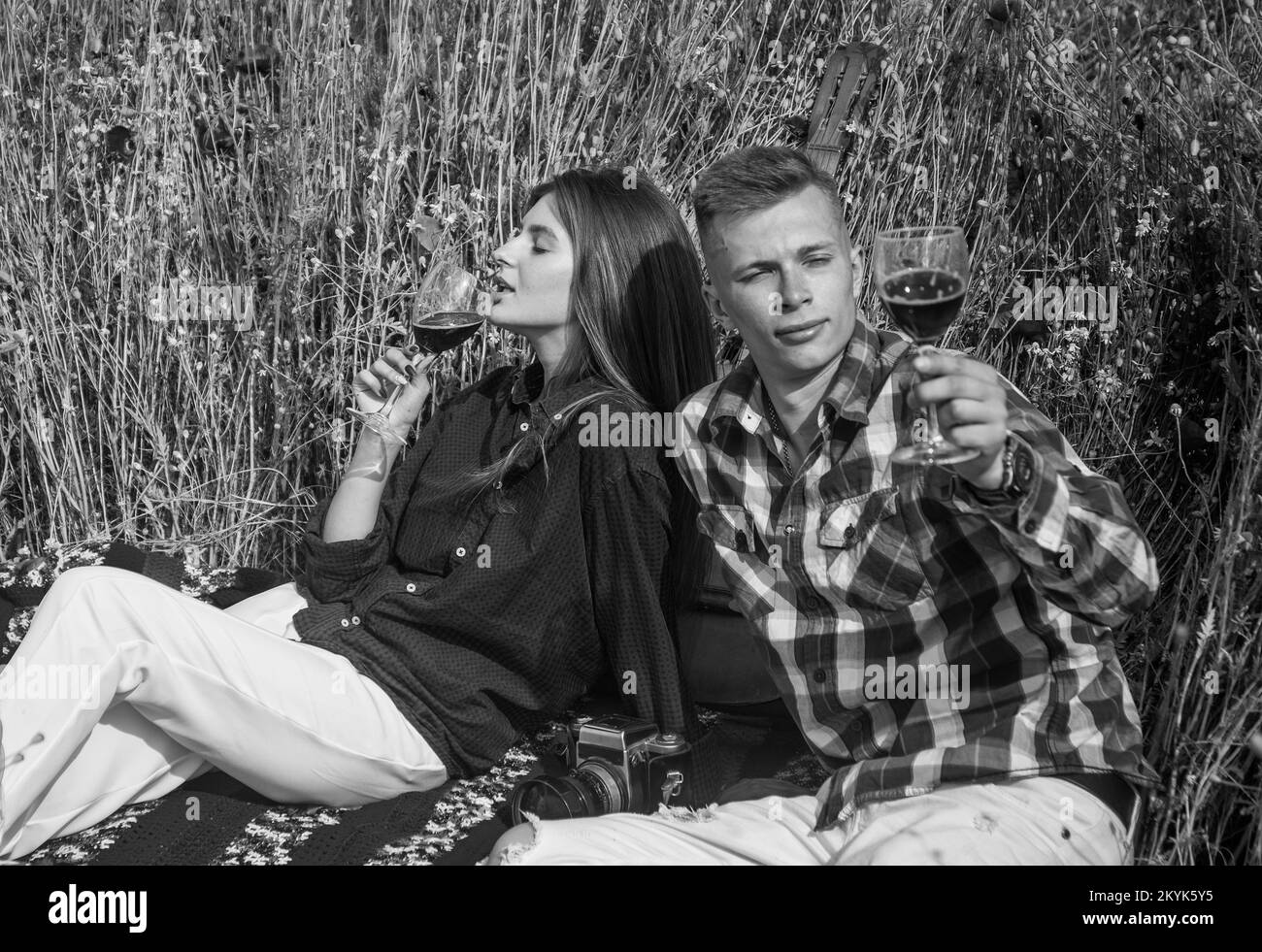 total relax. opium. spring countryside. lovers drink red wine in flower