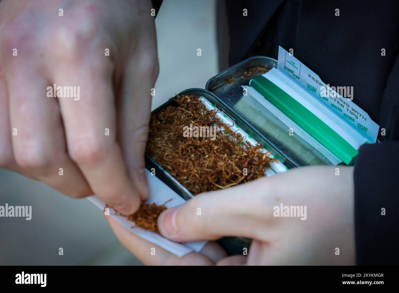 Hand Rolling Tobacco Person Rolling A Hand Made Cigarette Stock Photo hand-rolling-tobacco-person-rolling-a-hand-made-cigarette-stock-photo