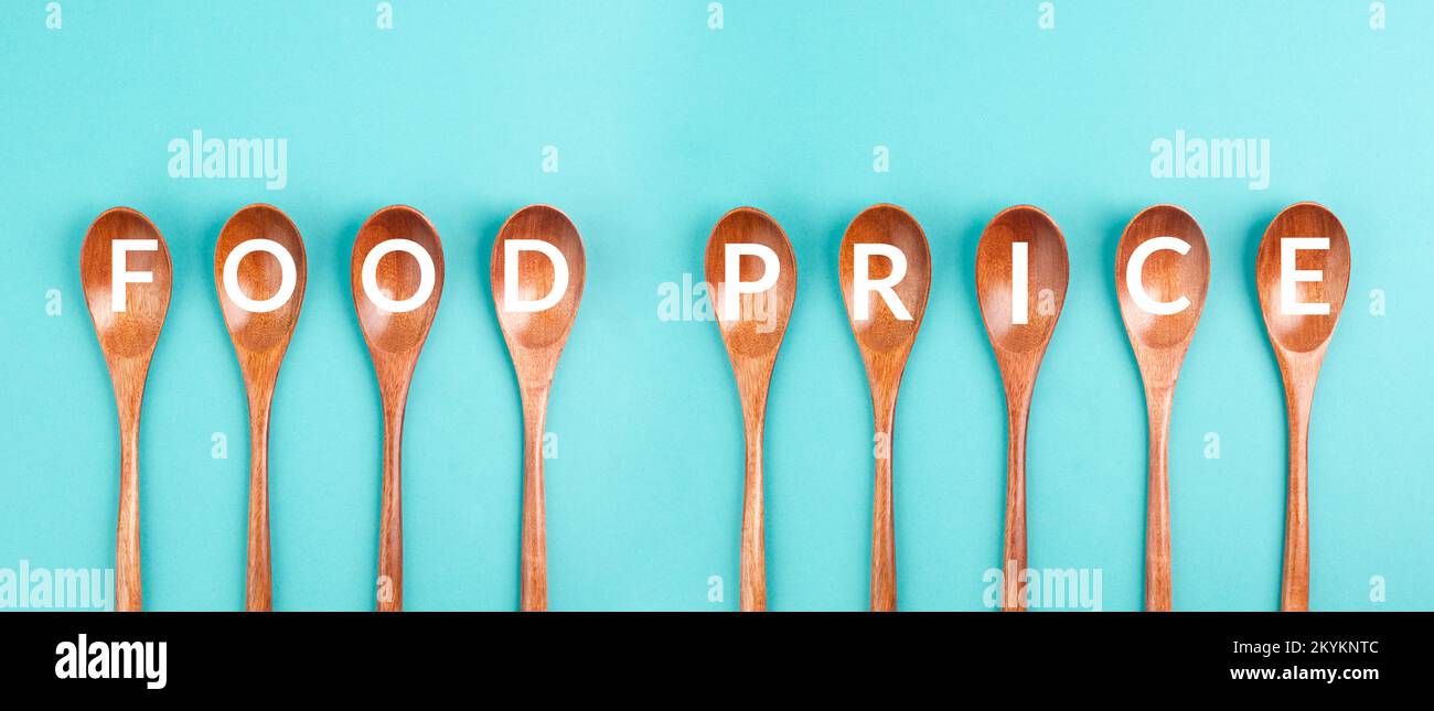 Wooden spoons with the words food prices, financial crisis and shortages, supply chain problems Stock Photo