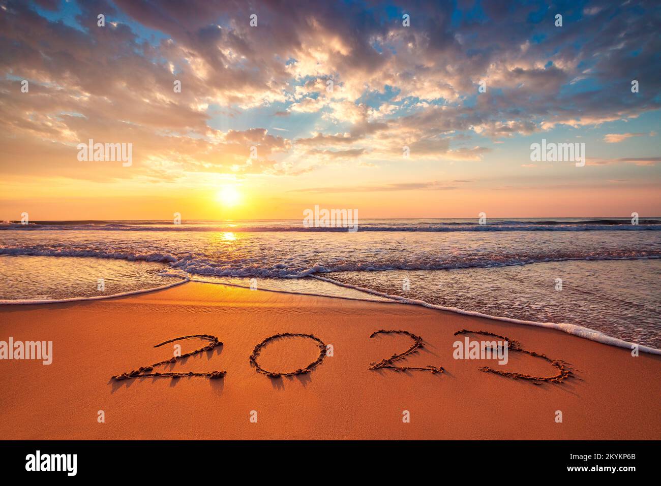 Happy New Year 2023 ocean sunrise on the beach shore concept Stock Photo