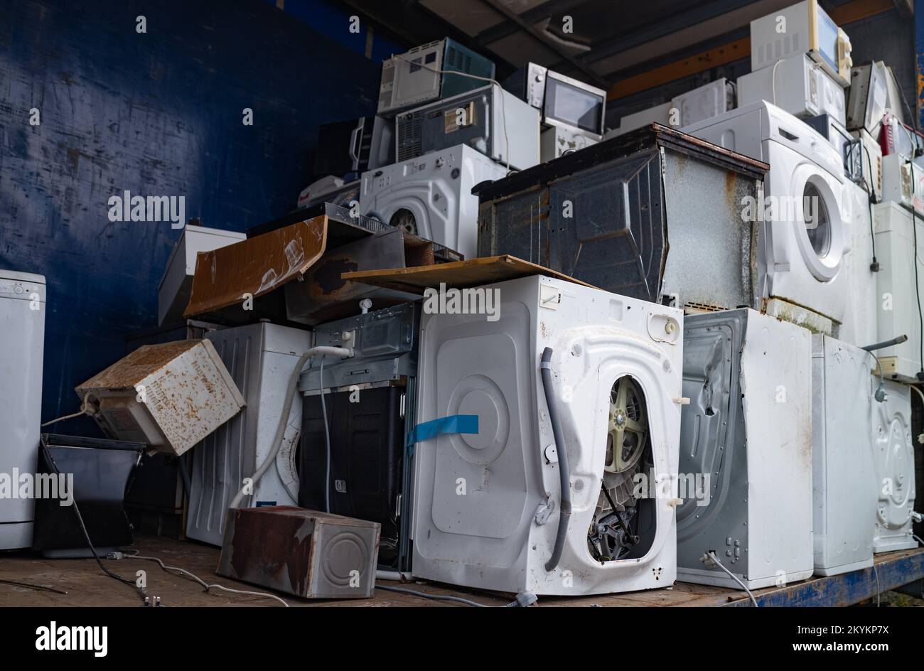 Old broken washing machines and other old electric appliances pilled up