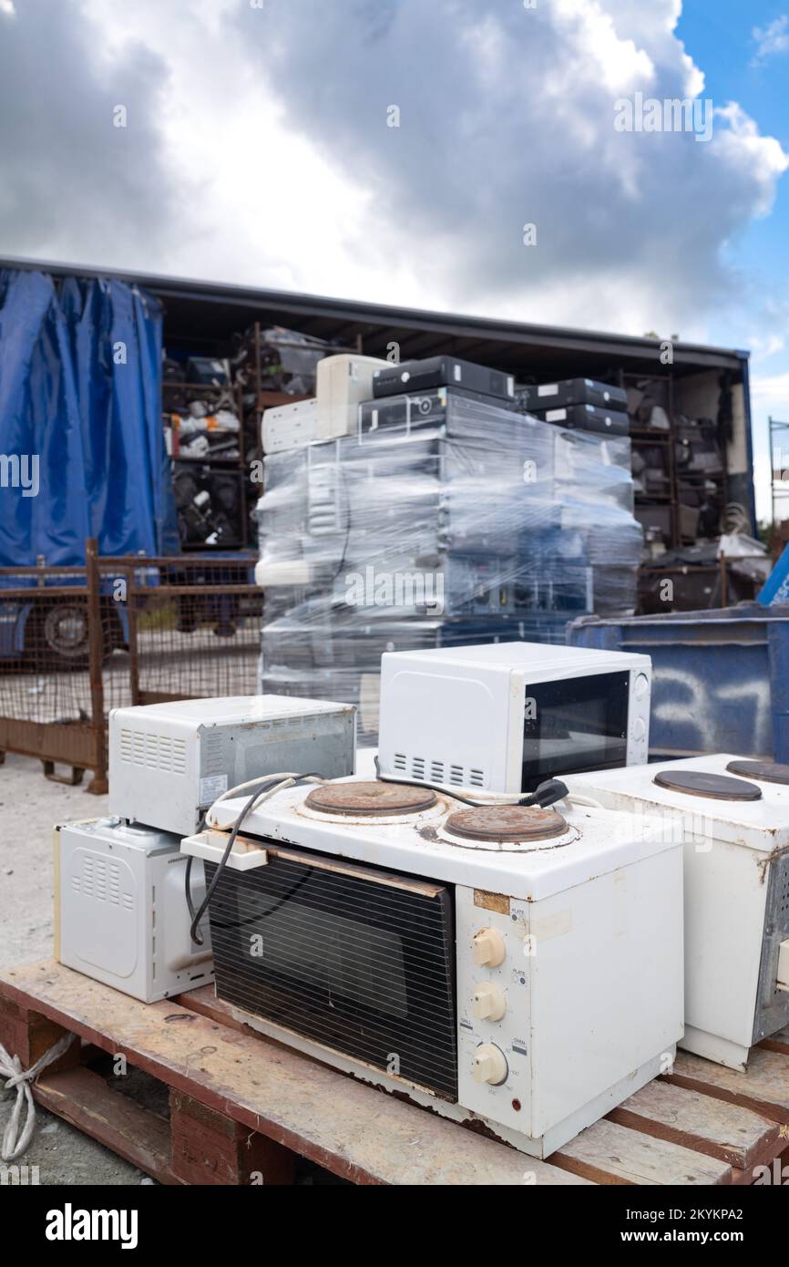 Old broken small hot plate oven and other old ewaste appliances pilled