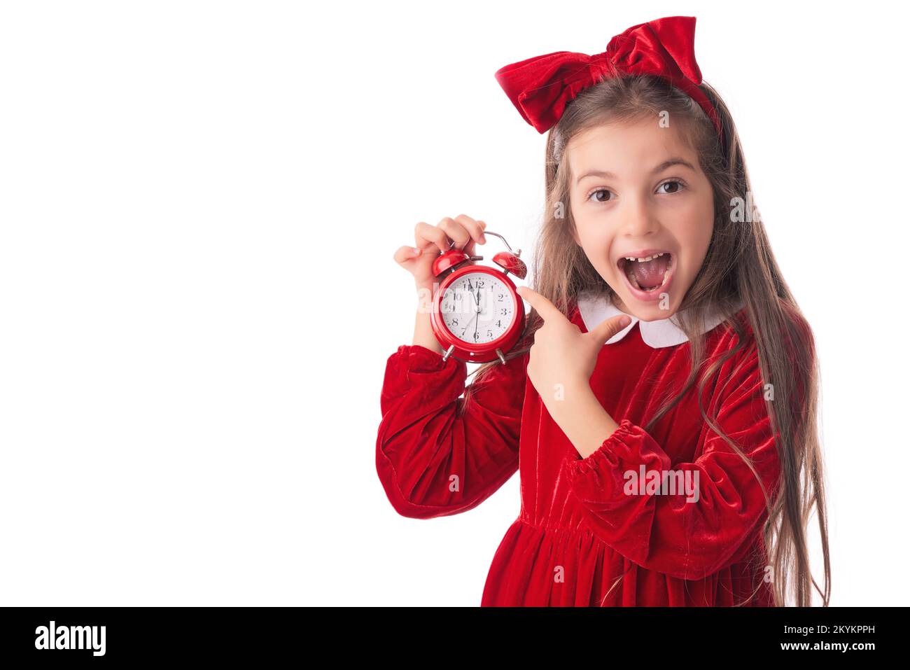 Christmas woman in Santa Claus dress posing with red alarm clock, midnight time for holidays presents Stock Photo