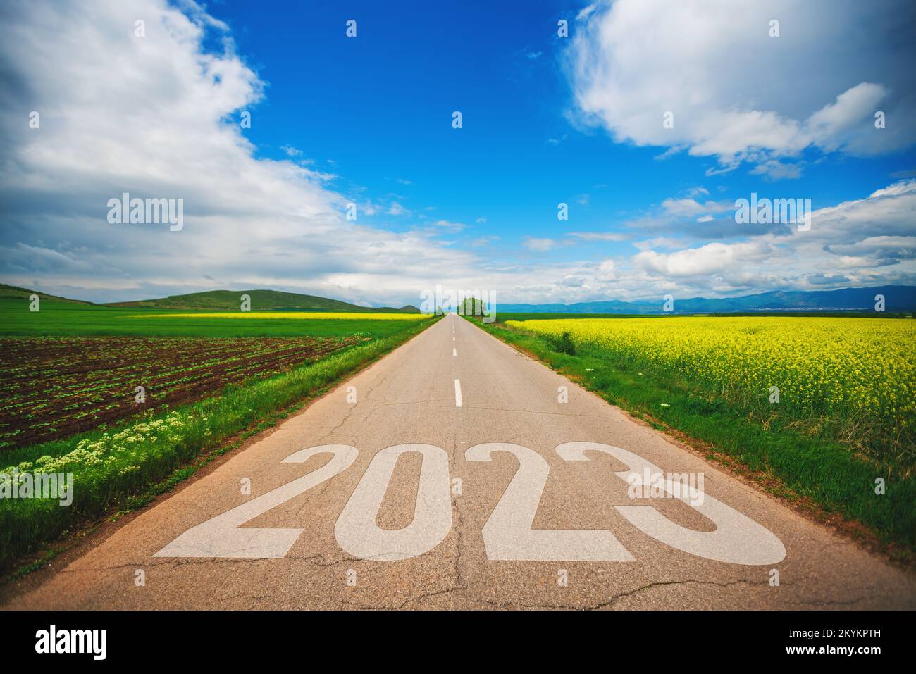 Travel, lifestyle and agriculture concept for new year 2023. Driving on an empty asphalt road at beautiful sunny day. Stock Photo