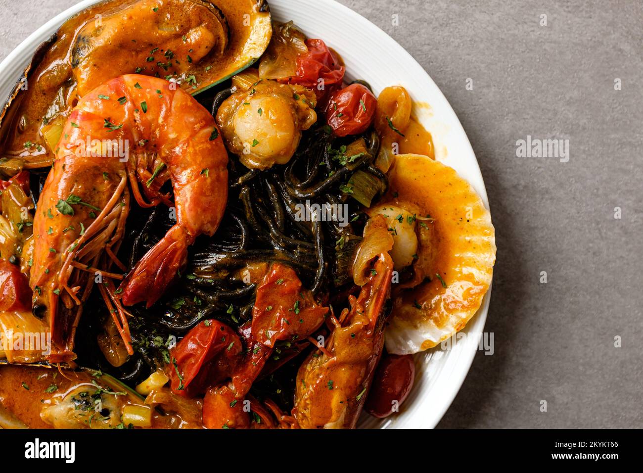 Pasta with bisque sauce. Pasta with Seafood. Squid ink spaghetti noodle