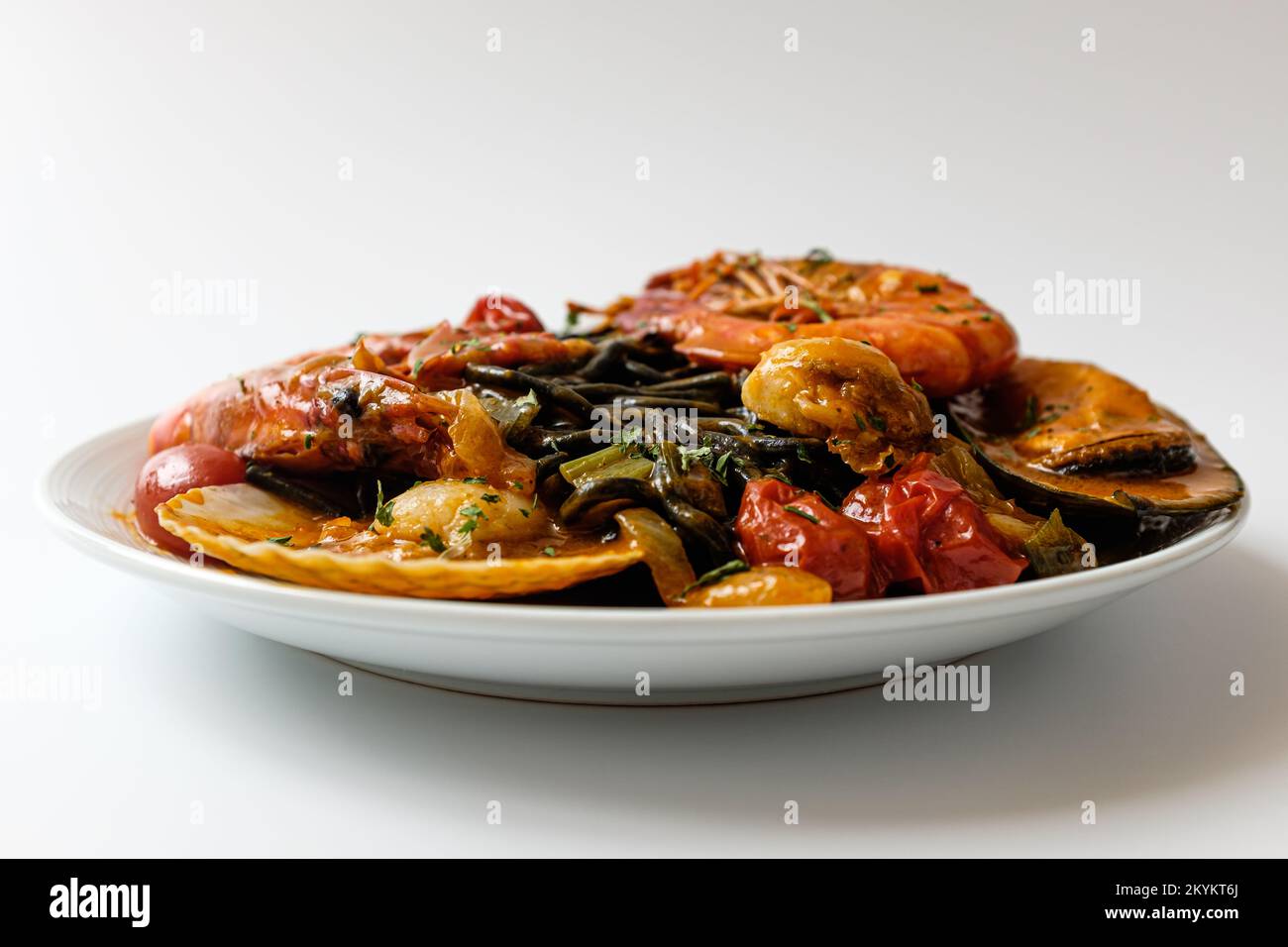 Pasta with bisque sauce. Pasta with Seafood. Squid ink spaghetti noodle