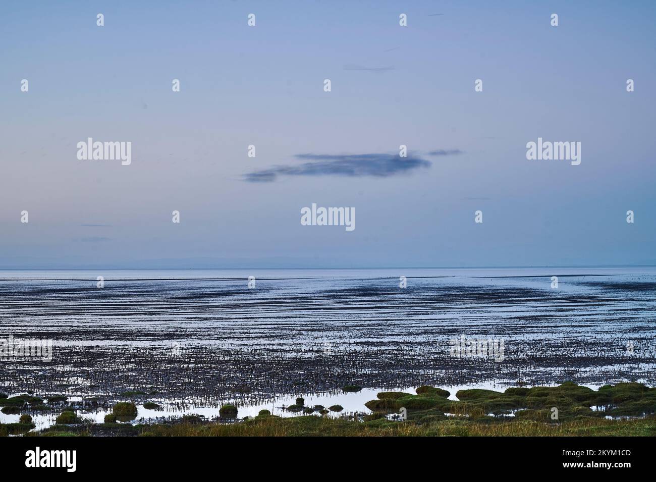 Dusk  in winter on Morecambe Bay at low tide Stock Photo