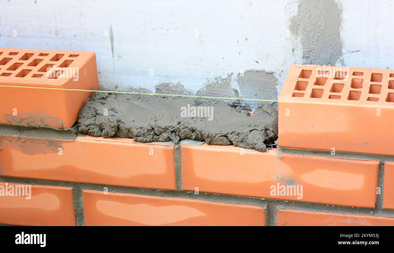 How to Build a Brick Wall. Bricklaying house wall, brickwork masonry