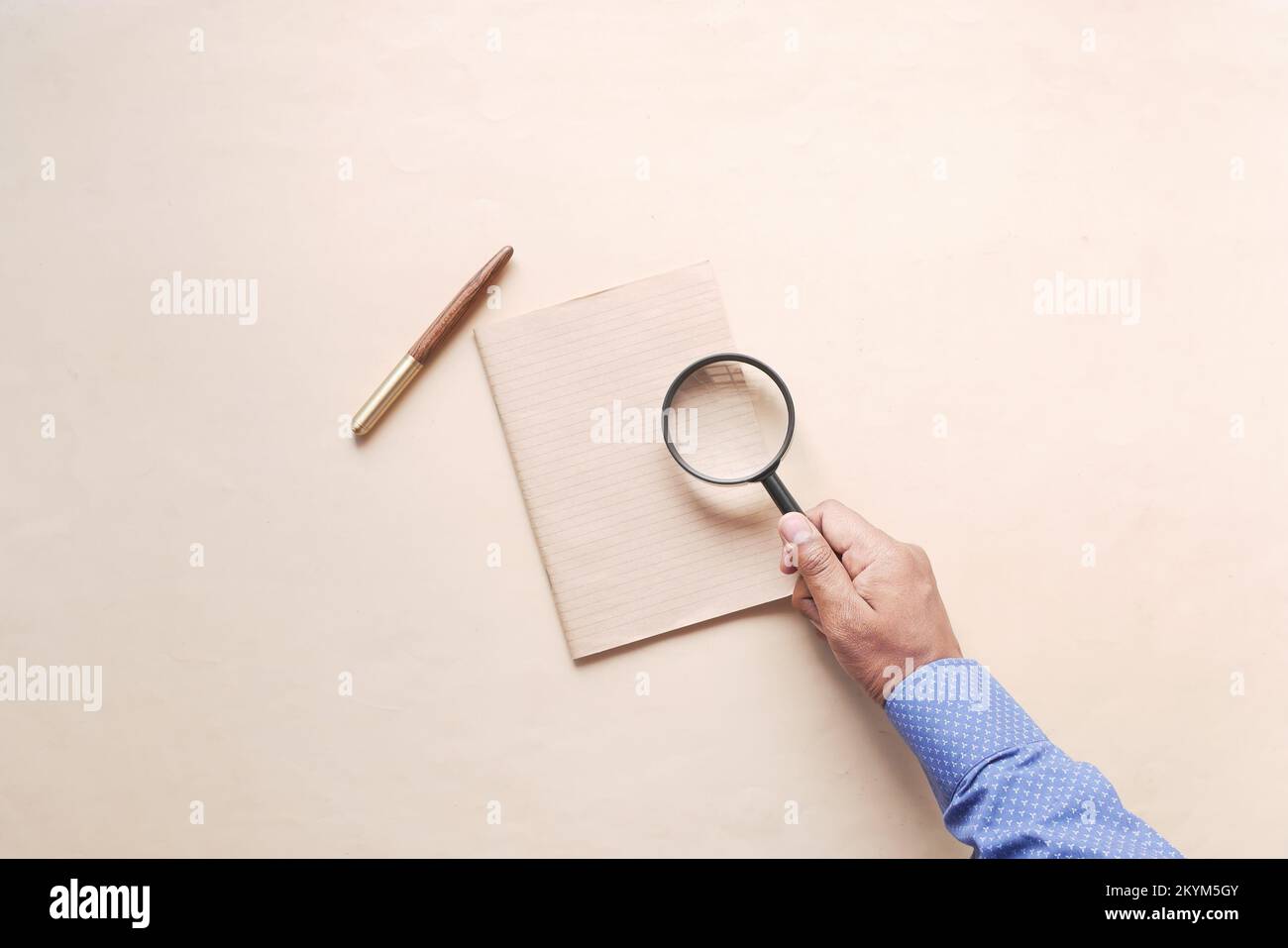 hand in magnifying glass inspecting 404 error.  Stock Photo