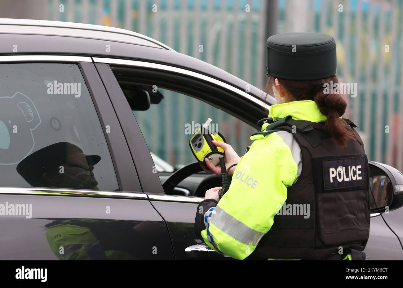 A police officer looking at a breathalyser at the launch of the 2022/23 police winter anti-drink/drug drive operation on Sydenham Road in Belfast. Picture date: Thursday December 1, 2022. Stock Photo