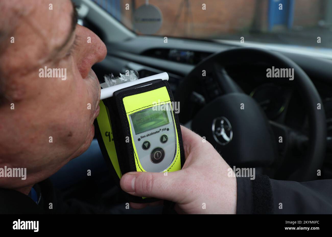 A driver blows into a breathalyser at the launch of the 2022/23 police winter anti-drink/drug drive operation on Sydenham Road in Belfast. Picture date: Thursday December 1, 2022. Stock Photo