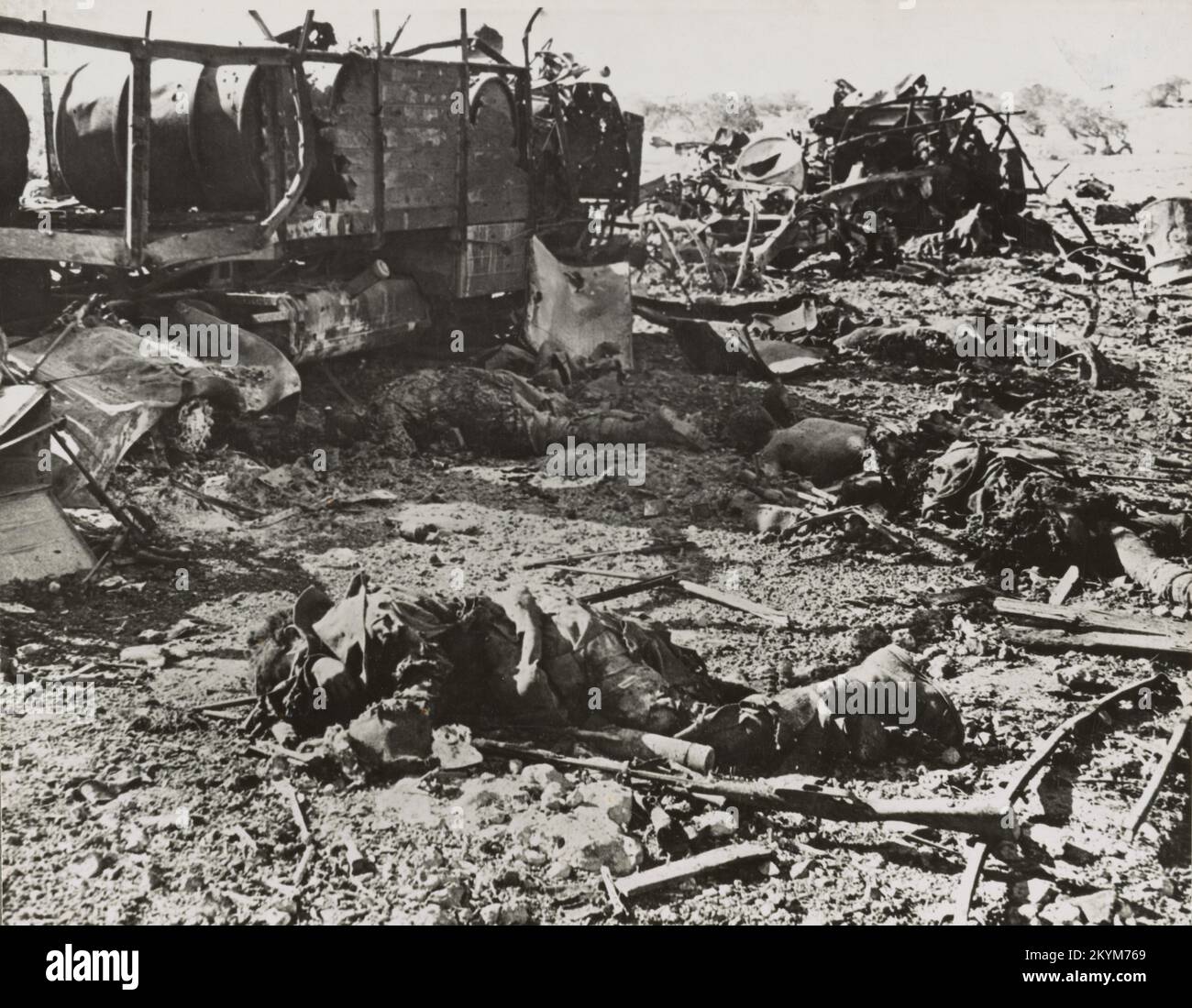 Vintage photo circa 1941 of dead Italian soldiers and destroyed vehicles after an attack by British artillery in the battle for Cyrenaica Libya. Stock Photo