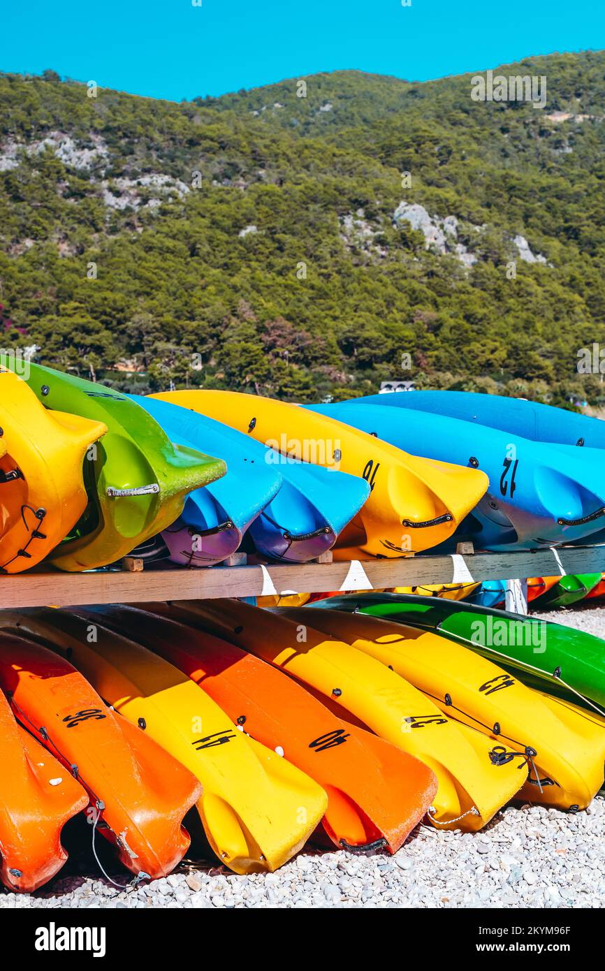 Colored kayak canoes on the sea beach. Summer holidays and activities on the water. Vacation, relax, sport concept. High quality photo Stock Photo