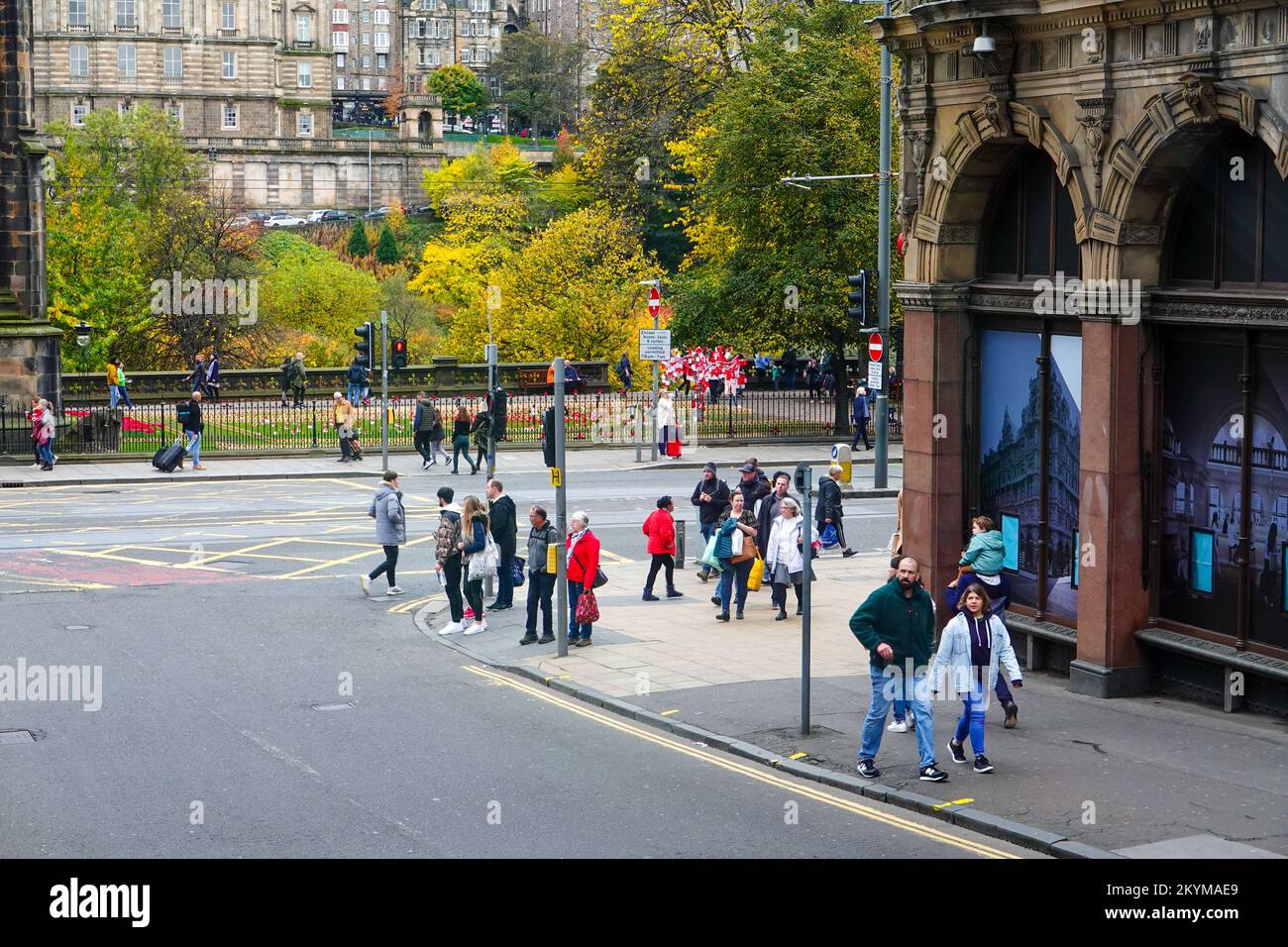 People walking in autumn at intersection of Princes and S. St David