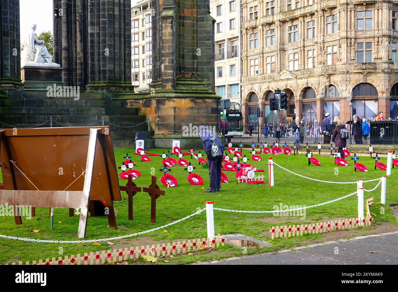 Man looking at wreaths, at the Garden of Remembrance, to honor the dead
