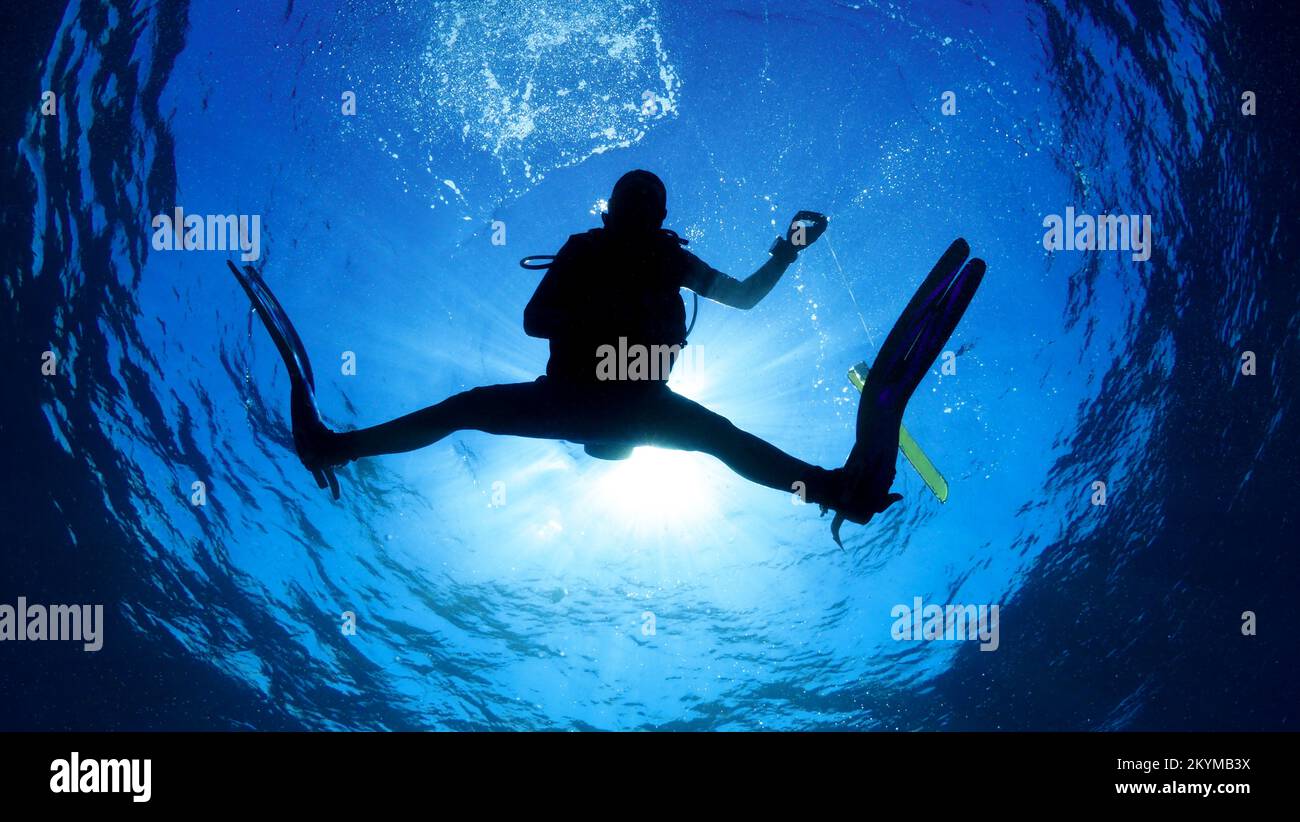 Silouhette of scuba diver making safety stop at the end of dive Stock