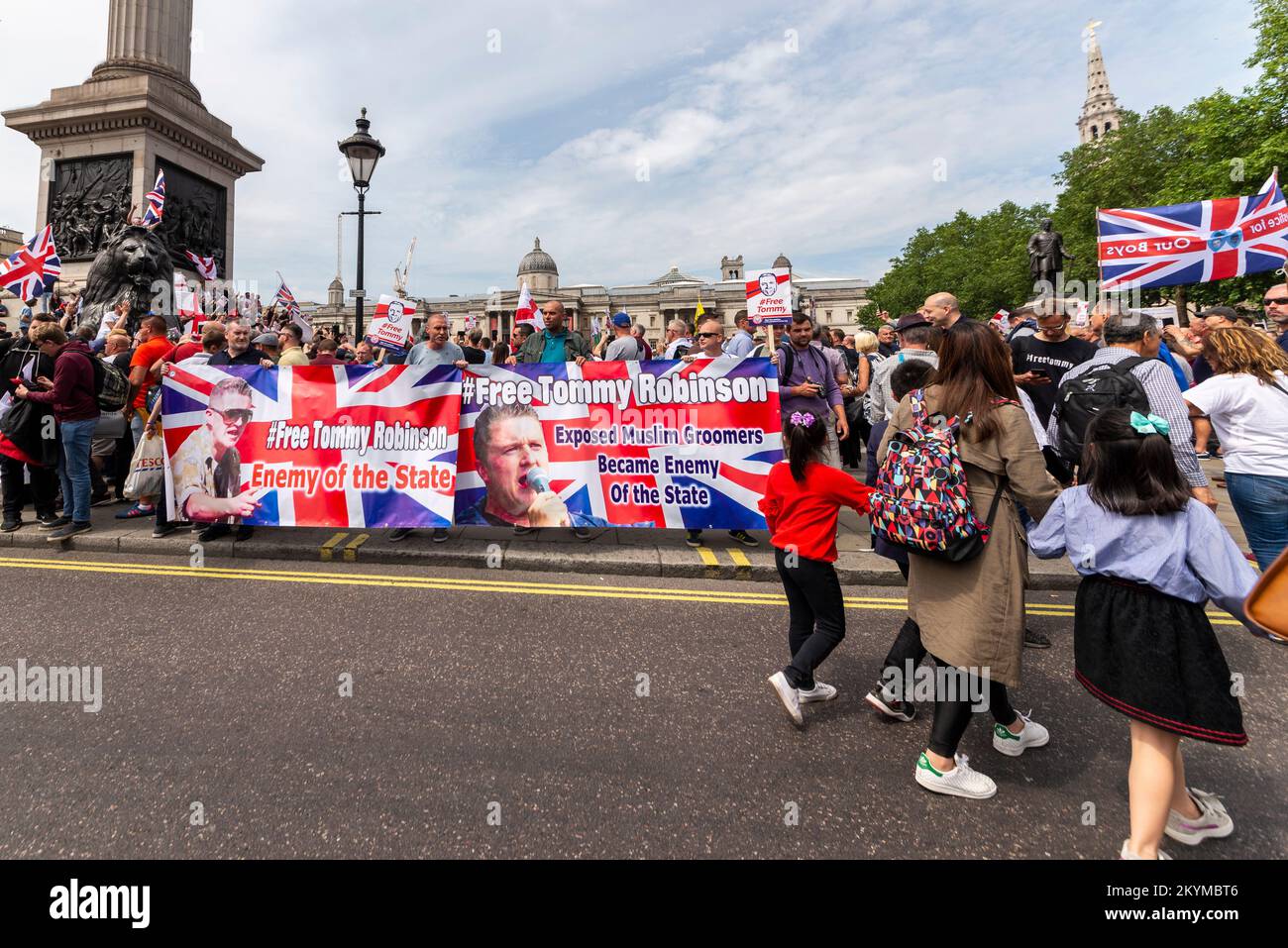 Supporters of Tommy Robinson, such as the EDL, protested in London demonstrating for his release after arrest. Young family passing banners. Children Stock Photo