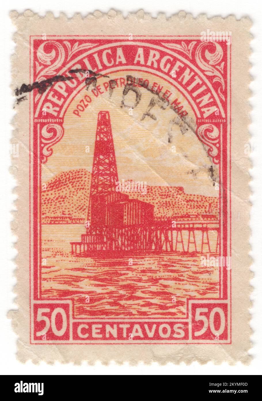 ARGENTINA - 1936: 50 centavos red and orange postage stamp depicting Oil Well (Petroleum industry). Around 35 million cubic meters each of petroleum and petroleum fuels are produced, as well as 50 billion cubic meters of natural gas, making the nation self-sufficient in these staples, and generating around 10% of exports. The most important oil fields lie in Patagonia and Cuyo. A network of pipelines (next to Mexico's, the second-longest in Latin America) send raw product to Bahia Blanca, center of the petrochemical industry, and to the La Plata-Greater Buenos Aires-Rosario industrial belt Stock Photo