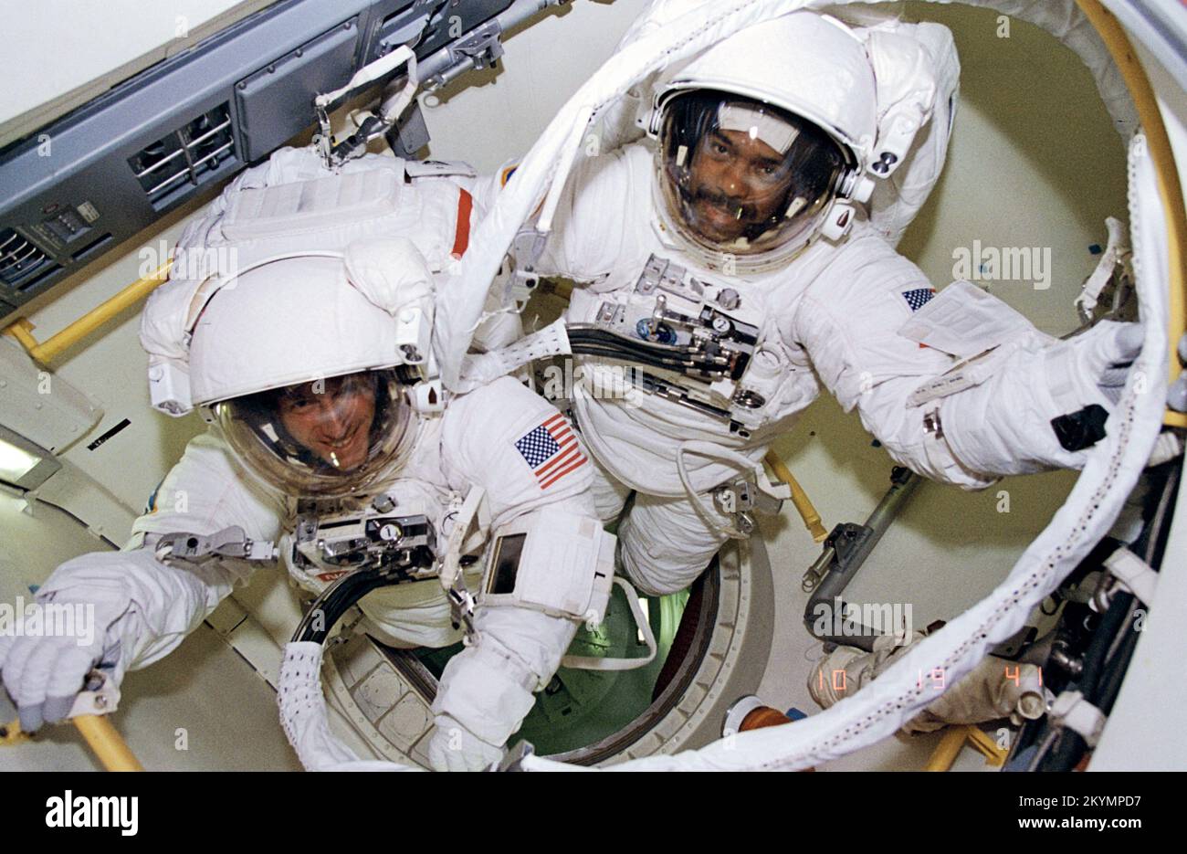 Astronauts Harris and Foale ready to egress airlock for EVA Astronauts Bernard A. Harris Jr., STS-63 payload commander, (top right) and C. Michael Foale, mission specialist, are ready to egress airlock for an extravehicular activity on February 9, 1995. Others onboard the space shuttle Discovery were astronauts James D. Wetherbee, mission commander; Eileen M. Collins, pilot; mission specialists Janice E. Voss, and cosmonaut Vladimir G. Titov. On this spacewalk Harris became the first African-American to walk in space and Foale became the first British citizen to walk in space. Date Feb 9 1995 Stock Photo