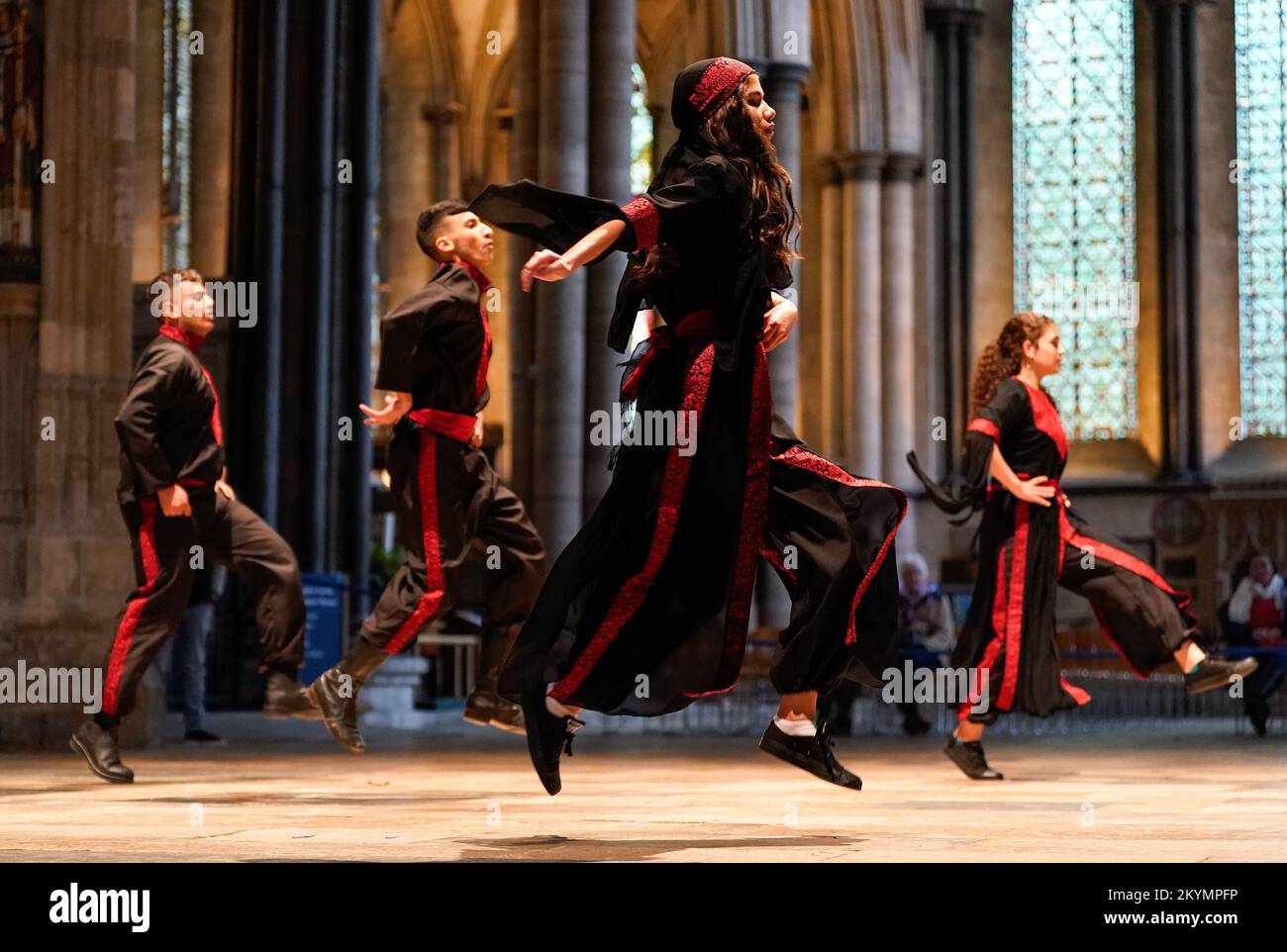 The Alrowwad Dabka Dance group from the Alrowwad Centre for Arts and Culture in Palestine, perform 'The Camps Gate' during the Bethlehem Cultural Festival at Salisbury Cathedral. Specially created to celebrate the 24th anniversary of the Alrowwad Centre for Arts and Culture, the performance brings together music, theatre and traditional Palestinian dabka dance to tell the story of the elderly Abu Ahmad, recounting his past and present, his displacement, life in a refugee camp and his hopes of freedom. Picture date: Thursday December 1, 2022. Stock Photo