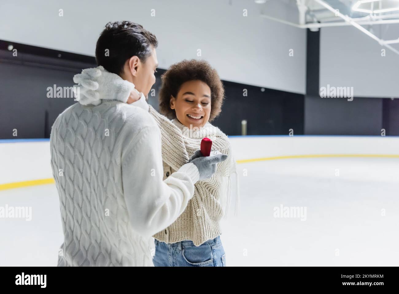 Cheerful african american woman embracing boyfriend with proposal ring ...